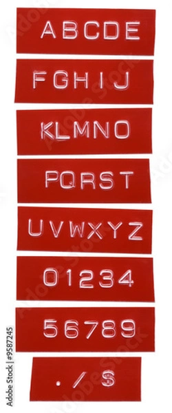 Obraz punch letter alphabet on red labeling tape