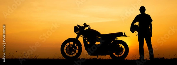Obraz Silhouette of Biker, motorbike parking with sunset background in Thailand. Young Traveller man standing and holding helmet beside motorcycle. Trip and lifestyle of motorbike concept-banner image.