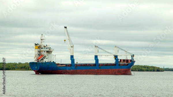 Fototapeta A large cargo sea vessel is at anchor, a dry cargo ship is at anchor