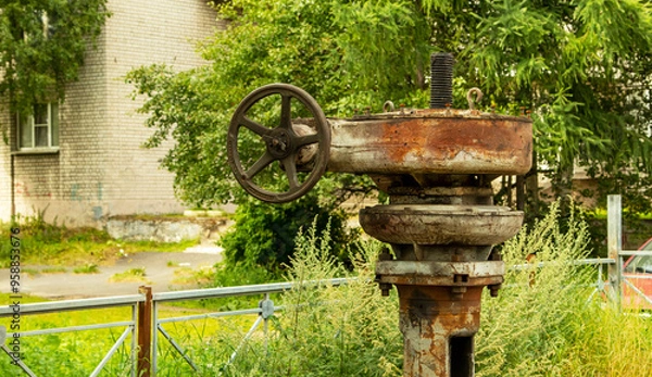 Fototapeta The valve of the Northern Streams gas pipeline is overgrown with grass