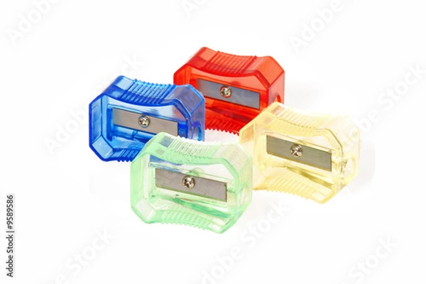 Fototapeta Four transparent colored plastic pencil sharpener