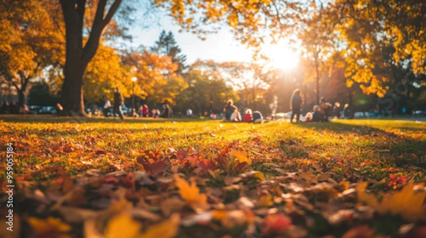 Fototapeta A lively autumn park scene with families enjoying the fall foliage, colorful leaves carpeting the ground, and a clear, sunny day.