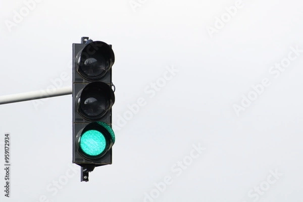 Fototapeta Green light on traffic lights. Isolated on white background. Negative copy space for placement of text.