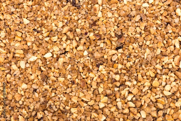 Fototapeta Pieces of chopped walnut as an abstract background texture