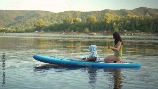 Fototapeta Embark on a Serene Paddleboarding Adventure on a Beautifully Calm Lake, Embracing Nature