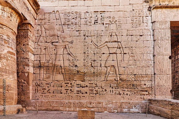 Fototapeta Famous wall relief of Ramesses III presenting captives of the Sea Peoples to Amun and Mut at the inner temple in Medinet Habu, the Mortuary temple of Ramesses III at Luxor,Egypt
