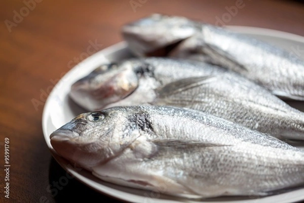 Fototapeta Fish on wooden background