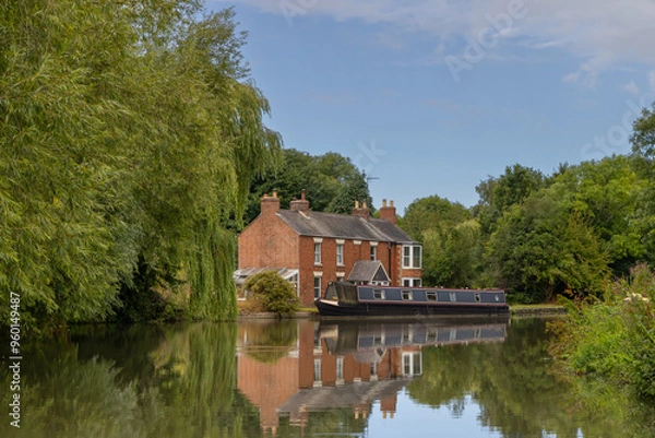 Obraz Narrowboat moored in front of  country house