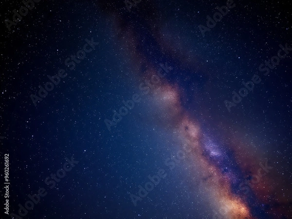 Obraz A stunning view of the Milkyway galaxy stretched across the night sky, filled with countless stars and cosmic clouds