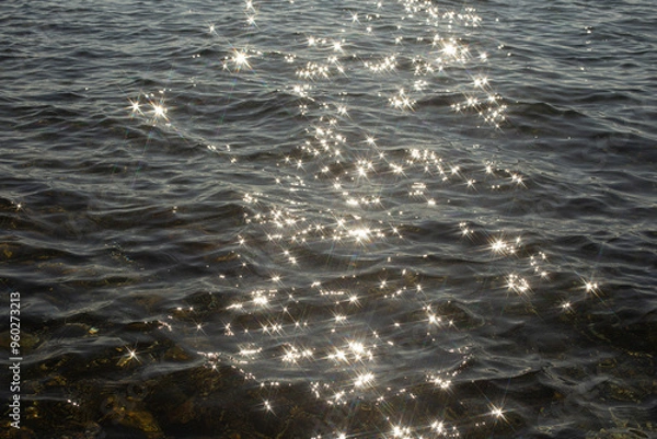 Obraz reflection sparkles on tiny ripples of sea water wave background, top view.