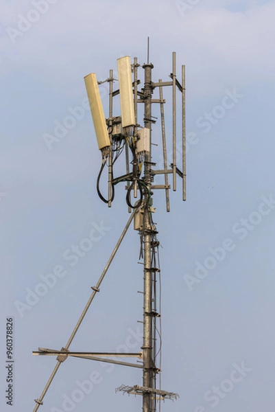 Fototapeta Communication tower top. Radio antenna Tower , microwave antenna tower on light sky background. wireless technology concept. communication development concept. image for objects and article.