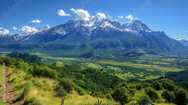 Fototapeta Majestic snow-capped mountain range surrounded by lush greenery. Nature and serenity concept