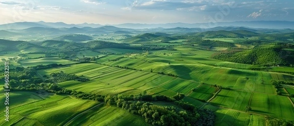 Fototapeta Vast Aerial View of Rural Agricultural Landscape with Farms and Fields Stretching to the Horizon
