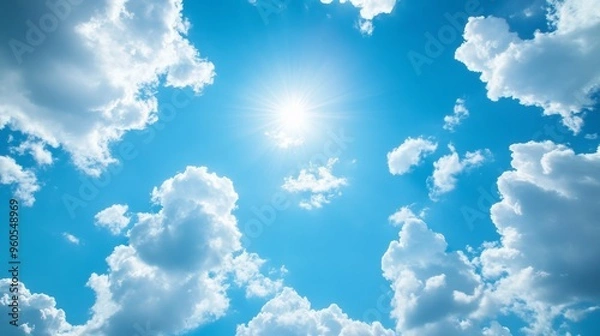 Fototapeta A bright blue sky filled with soft white clouds for a light and uplifting background