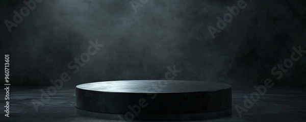 Fototapeta A round, black podium with a glossy finish, placed in front of a dark, dramatic background with subtle lighting to highlight the podiumâ€™s edges.