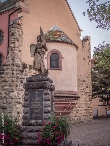Fototapeta Eguisheim, France - 09-09-2023 : Statue in tribute to people who died during world wars