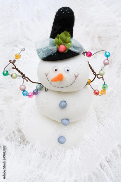 Fototapeta Snowman on white shiny garland making a background