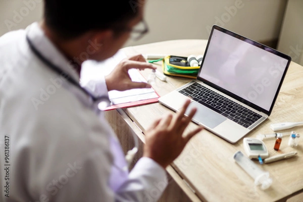 Fototapeta Man Doctor Explaining Over Telemedicine Video Call At Desk. Selective Focus, Focus On Laptop.