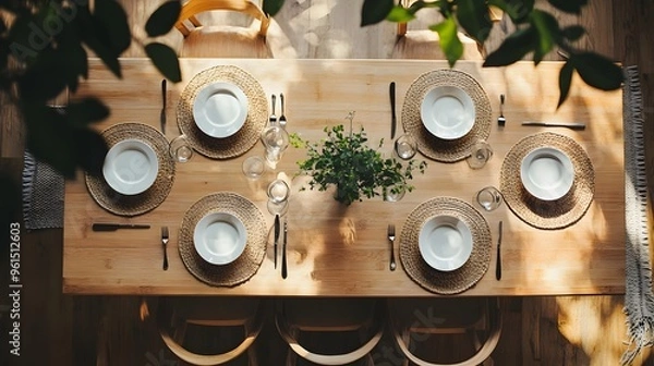Fototapeta A top-down view of a minimalist dining table with simple, geometric place settings