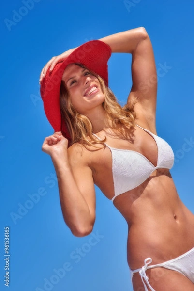 Fototapeta Woman, bikini and sky at beach with smile in summer or hot weather on holiday, break and rest in Bali. Below, female person and happy in swimwear on trip, vacation and travel to relax and chill