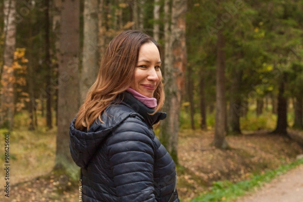 Fototapeta Healthy woman walking in autumn park outdoor on nature background, portrait