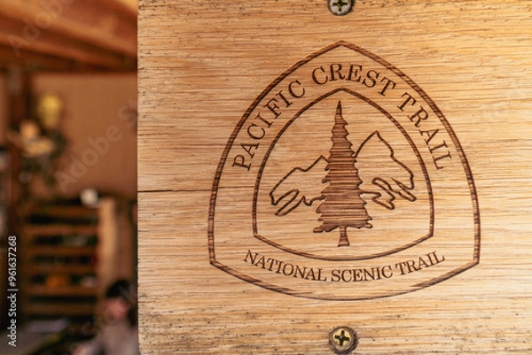 Fototapeta A wooden sign with a tree on it that says Pacific Crest Trail