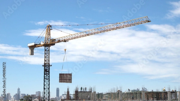 Fototapeta Industrial landscape with cranes on the blue sky