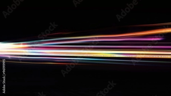 Fototapeta Colorful light streaks against a dark background, creating a dramatic display of motion and energy in a long-exposure photograph.
