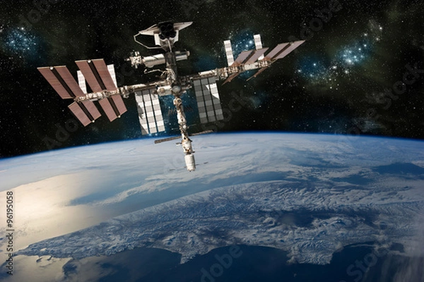 Fototapeta A depiction of the space shuttle docked at the international space station orbiting Earth. -  Elements of this image furnished by NASA