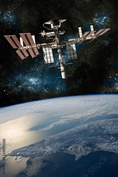 Fototapeta A depiction of the space shuttle docked at the international space station orbiting Earth. -  Elements of this image furnished by NASA
