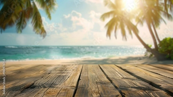 Fototapeta Wooden table top with blurry beach and palm tree backdrop - Ideal for showcasing products, symbolizing summer beach vibes.