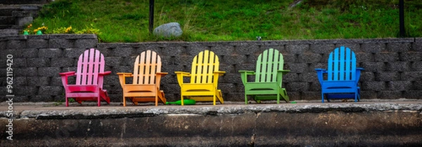 Obraz Colorful Adirondack chairs on a concreate dock in summer