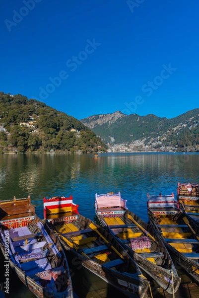 Fototapeta Boats tied at the banks of the famous Naini lake in Nainital, a preferred summer tourist in India. Clicked on 2 January 2022.
