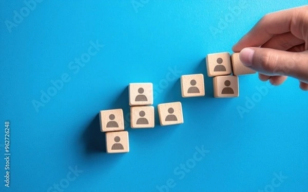 Fototapeta Building a Team: Wooden Blocks with Human Symbols