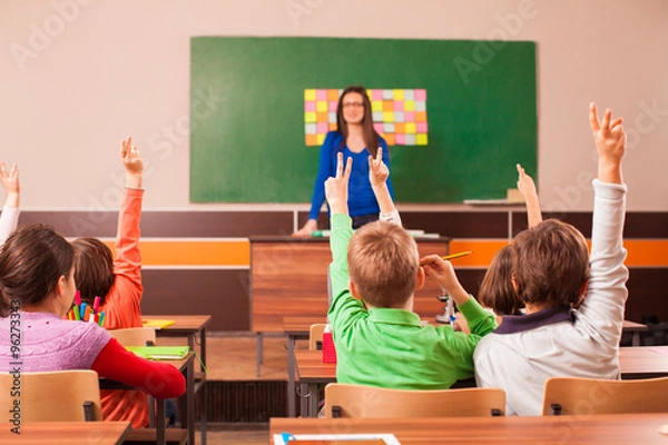 Obraz Children in elementary school are raised hand in clasroom