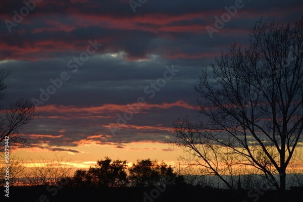 Fototapeta Sunset surrounded by colorful clouds