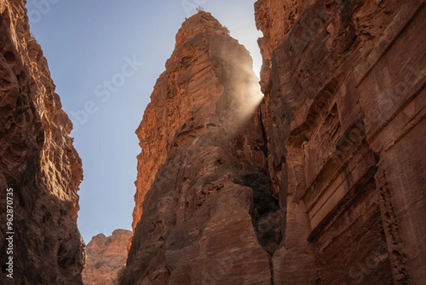 Fototapeta Rock Formation with Rays of Light in Petra. Beautiful Geological Landmark with Sun Ray in Jordan.