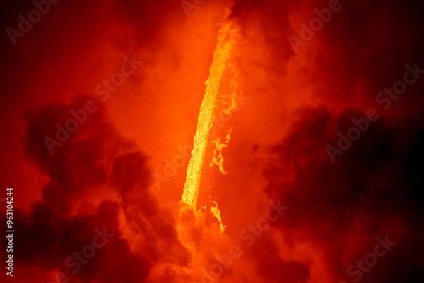 Fototapeta Lava tube flowing into ocean in Hawaii shows the violent explosions that happen when lava hits seawater.