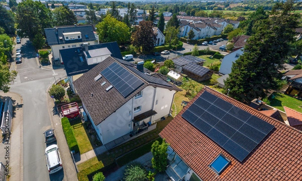 Fototapeta Solar panels on private roof tops in Germany on a summer day