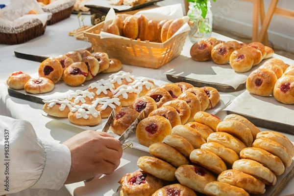 Fototapeta Buffet with a large selection of tartlets, cakes, buns at a catering event. Food for a coffee break at a conference