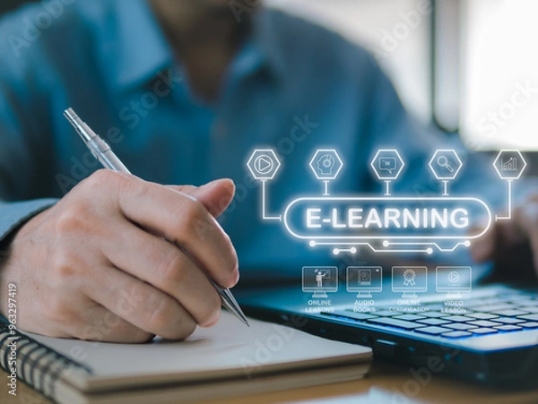 Fototapeta A businessman working on a laptop at a desk with various office tools, hand hold pen over a book