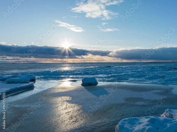 Fototapeta Winter at sea, sunset with ice, beautiful clouds