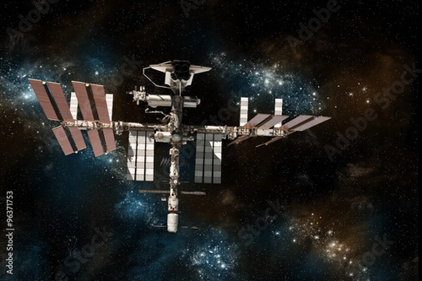 Fototapeta The International Space Station with the space shuttle docked on against a background of stars.