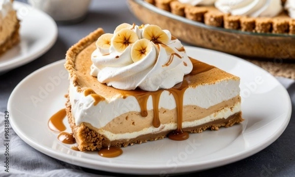 Fototapeta A classic banoffee pie with a graham cracker crust, layers of caramel, banana, and whipped cream