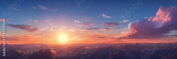 Fototapeta A breathtaking sunset over a mountainous landscape, with vibrant orange and pink hues illuminating the sky and contrasting with the dark clouds below.