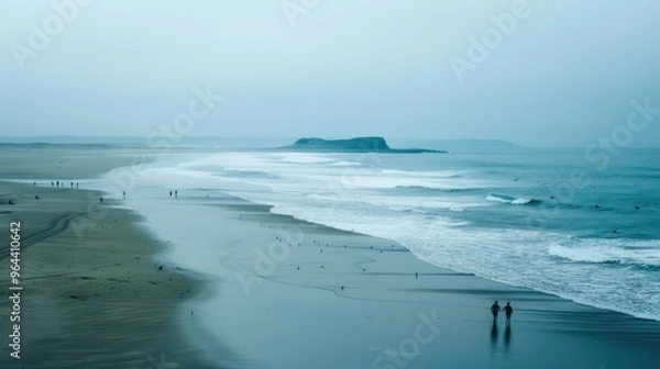 Obraz Couple Walking on a Sandy Beach With Sea in the Background