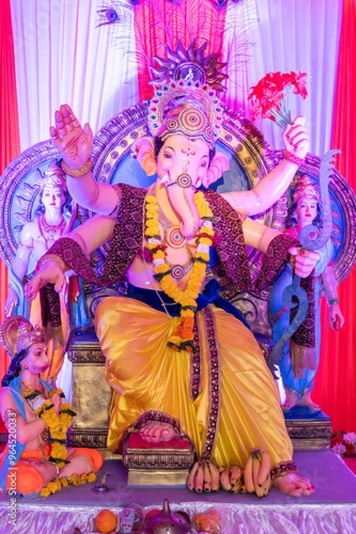 Fototapeta A Closeup shot Ganpati Installed in a Pandal during the 10 Day Ganesh Festival, the idols are immersed in heavy water bodies after the 10 days.
