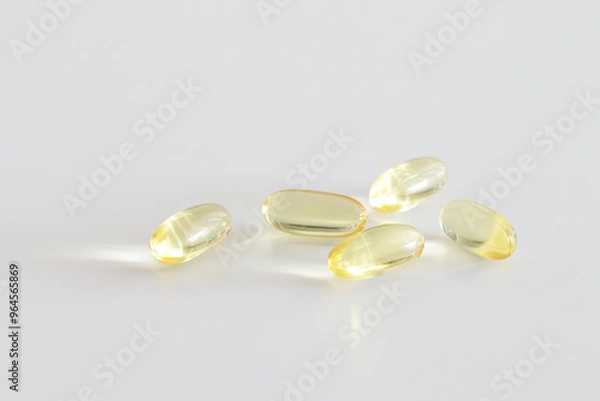 Fototapeta Soft Gel Capsules – Omega-3 Supplements on a white background. Healthy lifestyle. Minimalistic design