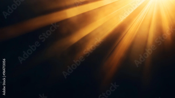 Obraz Abstract image featuring beams of warm golden light radiating through a dark, smoky background. The light creates a sense of warmth and illumination against the dark backdrop.
