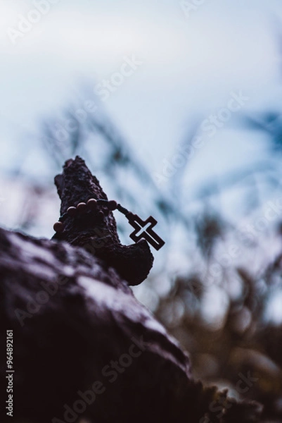 Fototapeta Wooden rosary with cross - with bokeh in background